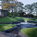 Serene Garden Landscape with Lush Green Grass Colorful Trees Small Pond and Stone Pathway