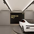 4S Shop Showroom Featuring White Car on Circular Display Platform With Car Posters on Back Wall