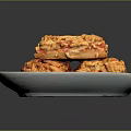 Crunchy Golden Baked Snacks With Granular Surface Stacked On White Plate