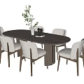 Oval Wooden Dining Table Set With Six Light Upholstered Chairs And White Vase Greenery Decor
