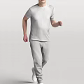 A man walking in casual white T-shirt and gray sweatpants against gray background