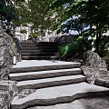 Natural Stone Stairs In Outdoor Garden With Lush Greenery And Rocks