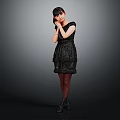 Woman in Black Dress and Stockings Standing with Hand on Cheek Against Gray Background