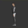 Man Wearing Gray Long Sleeve Top and Pants Standing in Studio with Gray Background