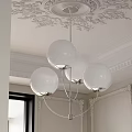 Modern Chandelier With Four White Globe Shades In Elegant Ornate Ceiling Interior