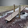 Wooden Outdoor Bench With Metal Handrails On Grass Snow And Dirt Ground