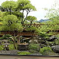 Traditional Japanese Garden With Stone Lanterns Bamboo Fence And Green Trees