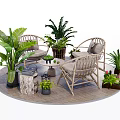 Outdoor Rattan Table And Chair Set With Green Plants On Wooden Deck