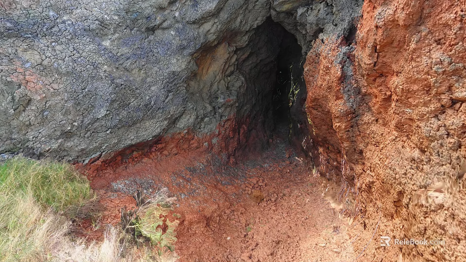 Scenic Cave Entrance With Gray And Red Rocks Red Soil And Green Plants 3d model 