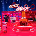 Coca Cola Exhibition Booth Red Themed Design With Large Bottle Models And Visitors