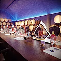 Elegant Wine Cellar Interior With Wooden Barrels Long Table And Wine Glasses