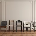 Various Styles of Dining Chairs Against Light Colored Walls With Decorative Moldings and Wooden Flooring