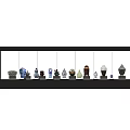 Ceramic Vessels With Various Colors And Different Shapes Arranged On Black Shelf