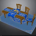 Wooden Dining Table With Blue Patterned Tablecloth And Chairs On Blue Rug With Book Cup