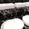 Three Elegant Modern White Washbasins on Black Marble Bathroom Countertop