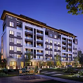 Modern Mid Rise Residential Building With Balconies Landscaped Garden Courtyard And Evening Lighting
