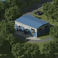 Industrial Factory Building With Blue Roof Surrounded By Green Trees And Parking Area Near Road