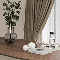 Green Plant in Glass Vase on Wooden Table with Curtain Indoor and White Balls Glassware