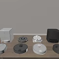 Different Colors And Styles Of Robotic Vacuum Cleaners As Daily Household Appliances On Wooden Floor
