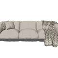 Plush Light Beige Three Seater Sofa With Geometric Throw Blanket And Black Metal Legs