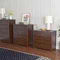 Three Wooden Chests of Drawers with Table Lamps Vases and Green Plant on Wooden Floor