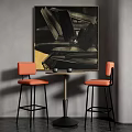 Orange Bar Stools With Black Metal Legs By Round Table And Abstract Painting On Gray Wall