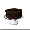 Two Chocolate Cakes on White Cake Stands with Chocolate Shavings and Decorations