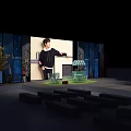Person Standing On Stage With Blue Beige Walls Green Lawn Area And Small Pavilion Benches