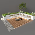 White L-shaped Outdoor Sofa with Central Fire Pit Green Plants on Wooden Floor and Pebbles