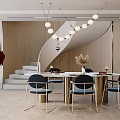 Modern Round Marble Dining Table With Blue Chairs Gold Frame Pendant Lights And Staircase