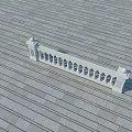 Building Exterior Wall Featuring White Balustrade With Circular Openings And Gray Tiles