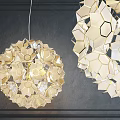Modern Geometric Chandeliers With Hexagonal Patterns And Golden Accents On Dark Wall