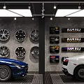 Car 4S Dealership Showroom with Wall Mounted Wheels and Blue and White Cars Parked Inside