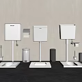 Three White Toilet Tanks Side By Side With Squat Pans Accessories Dark Floor Light Wall