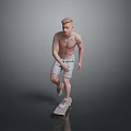 Shirtless Male In Light Shorts Riding Skateboard On Reflective Gray Floor