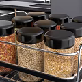 Kitchen Food Storage Jars With Black Lids Containing Grains Spices On Metal Rack