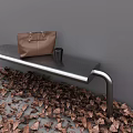 Sturdy Metal Outdoor Bench With Brown Bag Black Cup And Fallen Leaves By Gray Wall