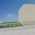 Outdoor Metal Railings Along Building Ramp with Green Grass and Gray Tiles