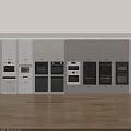 Various Styles And Colors Of Kitchen Ovens Neatly Arranged In White Cabinets With Wooden Floor