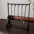 Traditional Chinese Calligraphy Brushes on Dark Wooden Rack with Brown Table and Green Plant