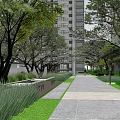 Residential Landscape With High Rise Buildings Lush Greenery And Modern Entrance Structure