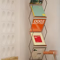 Modern Metal Frame Bookcase with Colorful Books and Circular Cutouts Wall