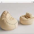 Two Beige Comfortable Rounded Fabric Bean Bag Chairs for Home Use