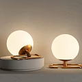 Two Modern Spherical Illuminated Table Lamps With Golden Brackets And White Bases