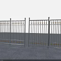 Sturdy Metal Fence With Golden Decorative Balls Against Green Hills Blue Sky And Gray Pavement