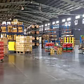 Organized Warehouse Interior With Shelves Stacked Boxes Barrels And Forklift
