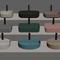 Various Colored Washbasins With Black Stands Neatly Arranged On Multi Tiered White Shelves