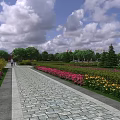 Park Landscape Featuring Paved Path Colorful Flower Beds Green Trees And Blue Sky