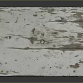 Distressed White Wooden Table With Weathered Surface And Simple Straight Legs