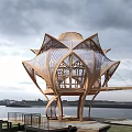 Lotus Shaped Wooden House by Waterfront with Open Design and Wooden Platform Under Cloudy Sky
